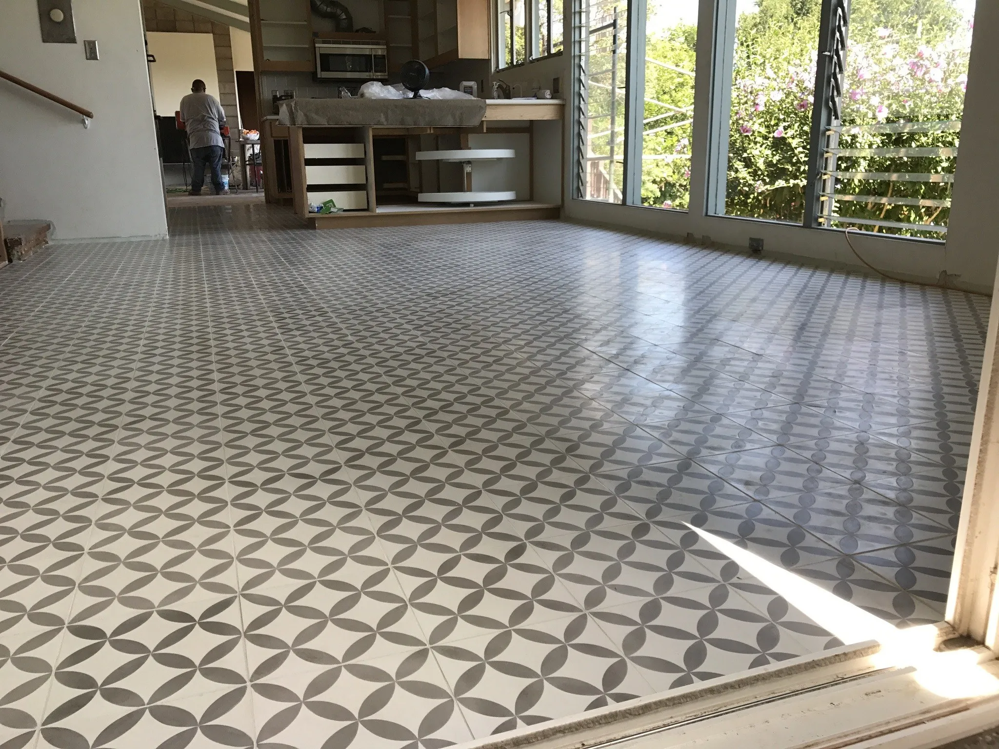 Gray and white geometric cement tile floor in a bright open living room