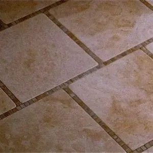 Travertine floor tile with a thin decorative border strip