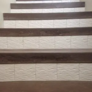 Stair risers in white wave-textured tile with wood-look tile treads