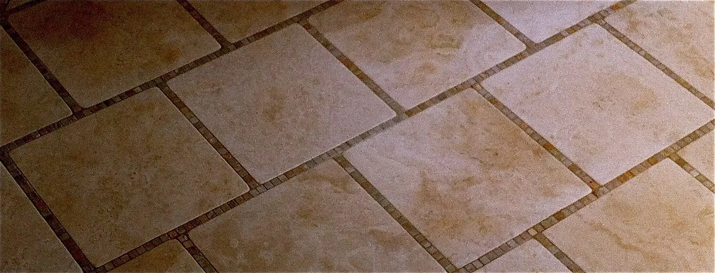 Travertine floor tile with a thin decorative border strip