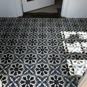Black and white floral-pattern cement tile floor