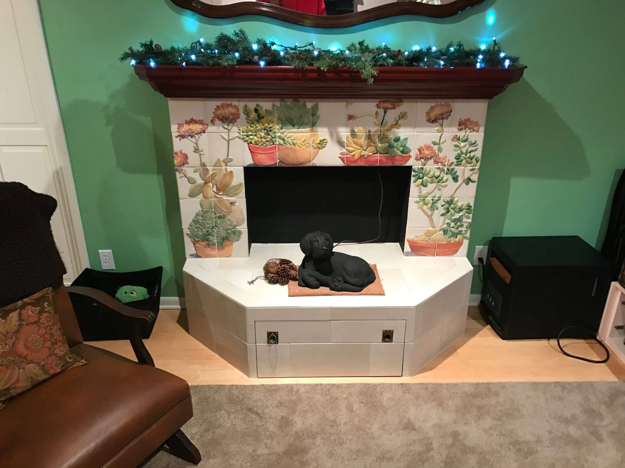 Fireplace surround with hand-painted cactus and succulent tile murals and a white tile hearth