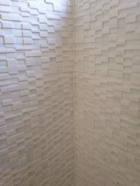 White textured 3D wall tile in a shower corner