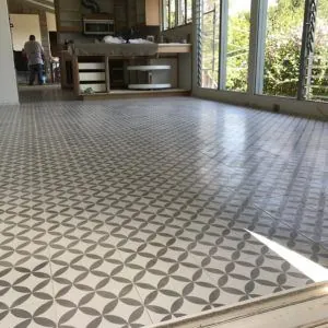 Gray and white geometric cement tile floor in a bright open living room